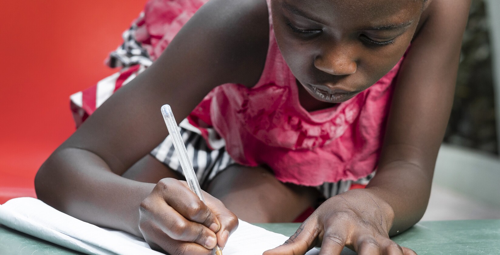 medium shot girl writing notebook
